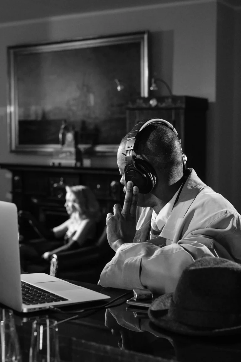 A gentleman sitting and listening with a device