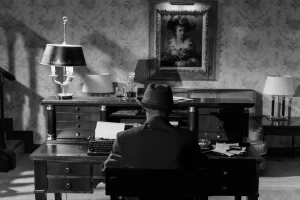 The back of a man sitting at a desk old fashion image in black and white